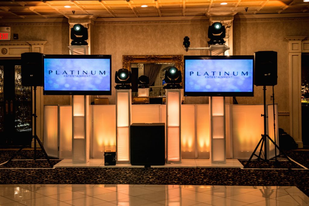 amber lit stage with 2 video screens showing Platinum logo