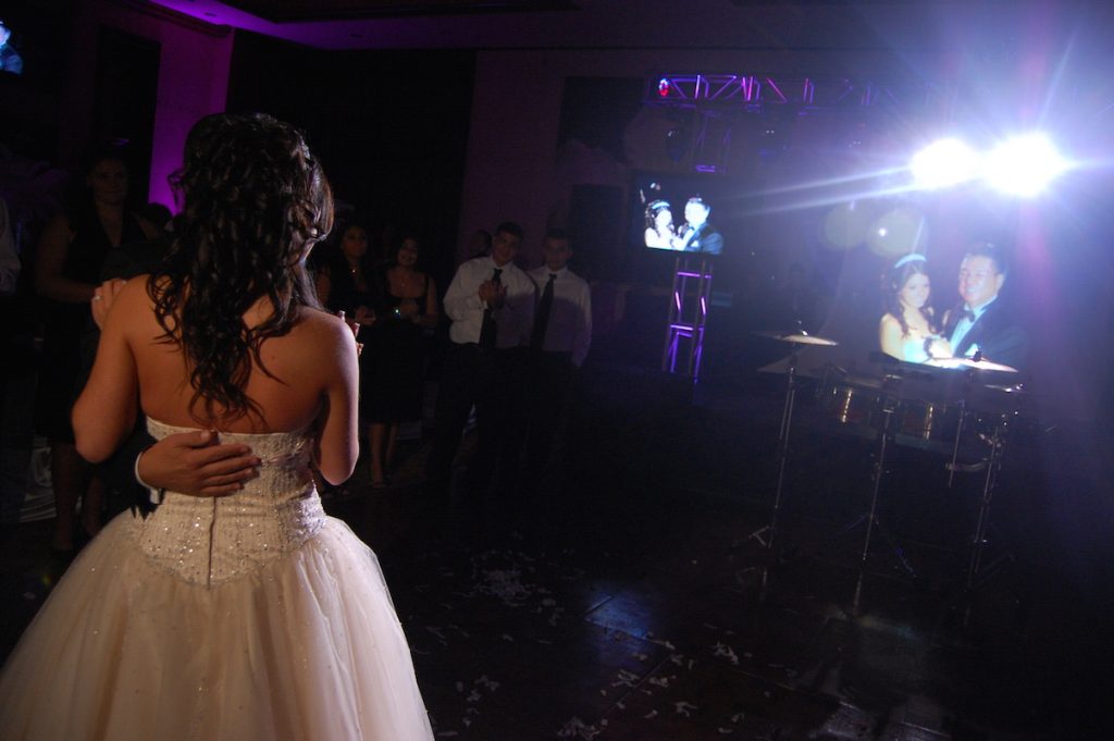 video displays showing the bride and her father's dance